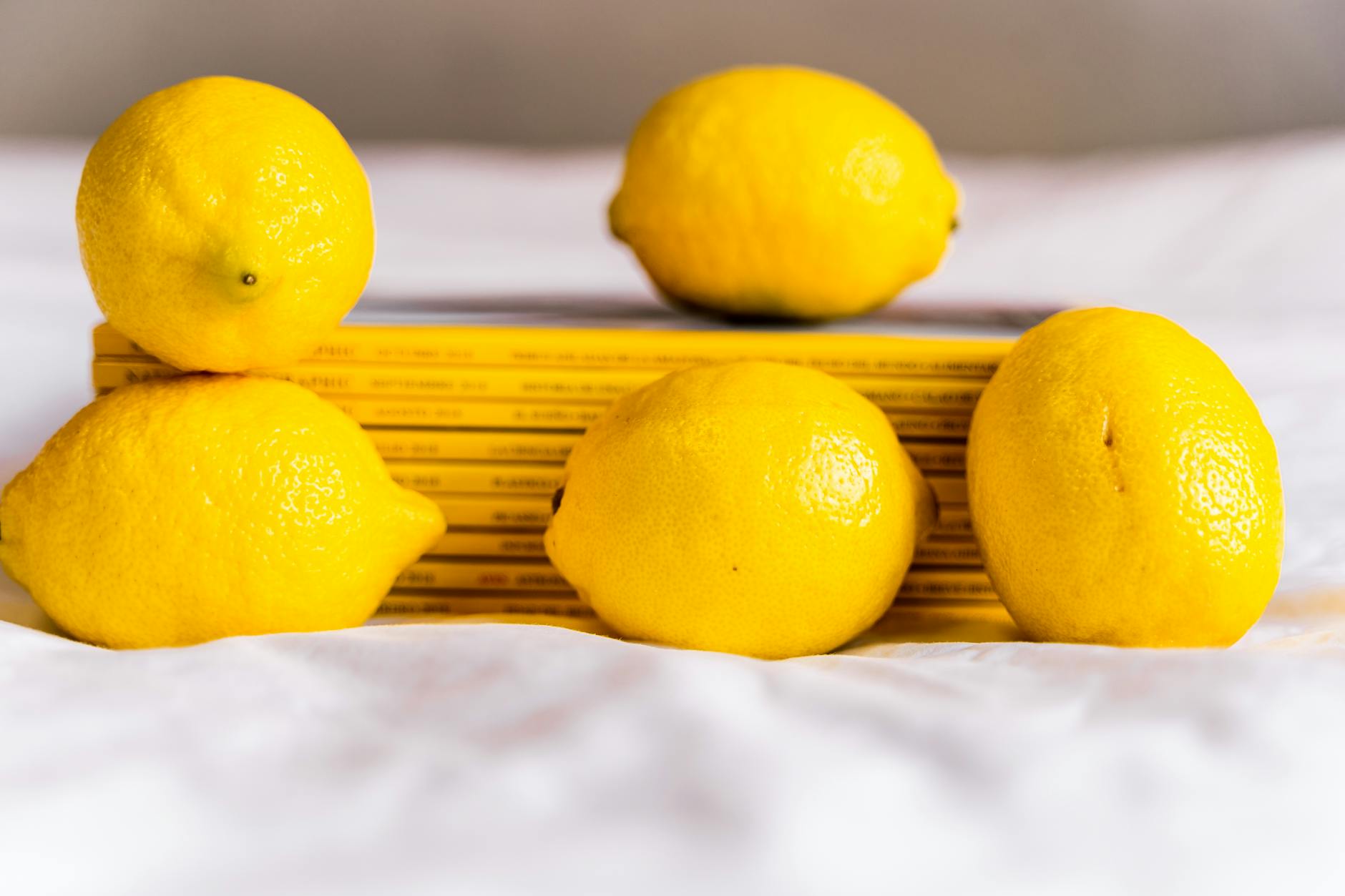 Fresh lemons on a white surface, symbolizing the clean, minimalist design of Official Nancy Lem products
